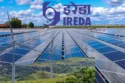 A red downward graph showing IREDA share price fall with renewable energy icons in the background.