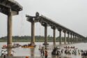 Collapsed portion of the Gambhira Bridge with rescue teams retrieving vehicles from Mahisagar River in Vadodara, Gujarat.