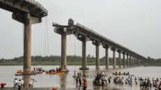 Collapsed portion of the Gambhira Bridge with rescue teams retrieving vehicles from Mahisagar River in Vadodara, Gujarat.