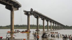 Collapsed portion of the Gambhira Bridge with rescue teams retrieving vehicles from Mahisagar River in Vadodara, Gujarat.